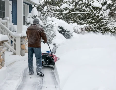 bigstock-Man-using-snowblower-to-clear--77541071